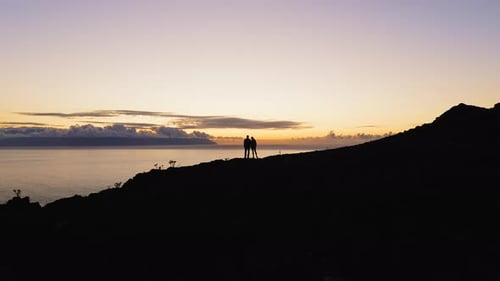 Couple Silhouette Two Tourists Climbed to the Top of Mountain and Raised Hands Up During Sunset
