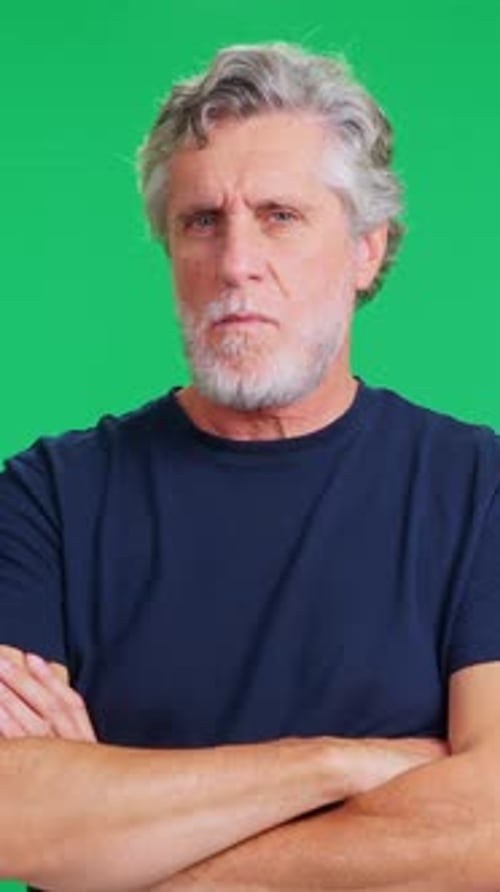 Angry Senior Man Crossing His Arms on a Green Screen