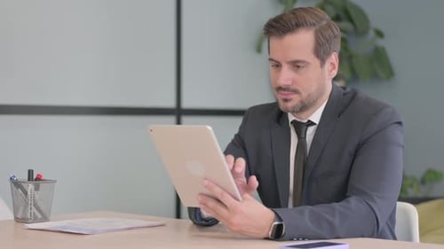 Man in Suit Using Tablet in Modern Office