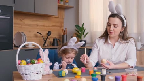 Mother and Daughter Decorate Easter Eggs Together at Home