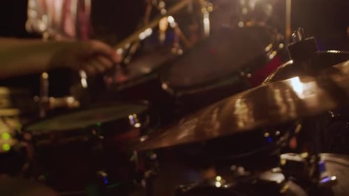 Drum Player Performing Music on a Stage with Flashing Lights Close Up and Powerfully Hitting Drums