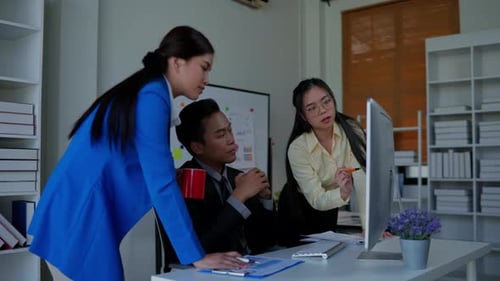 Business Colleagues Collaborating at Computer in Modern Office