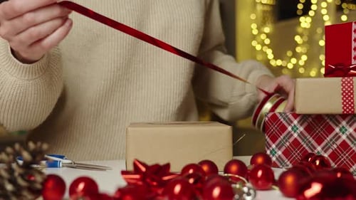 Woman wrapping christmas gift at home