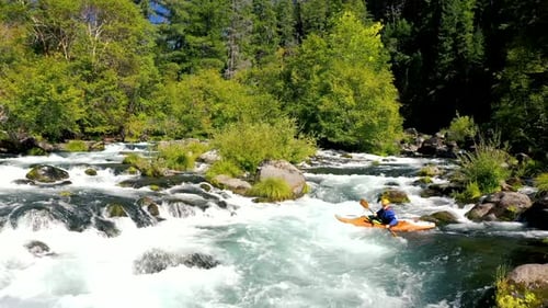 Aerial view of man whitewater kayaking the Mill Creek section of water on the upper Rogue River in S