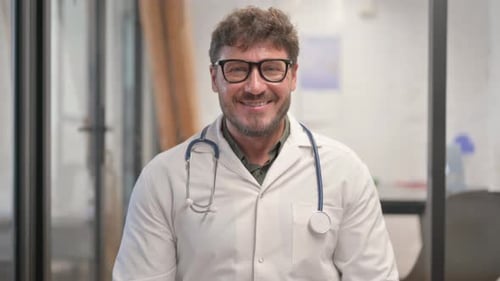 Portrait of Smiling Male Doctor Looking at Camera