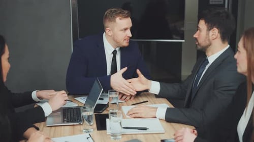 Business People in Corporate Meeting with Handshake