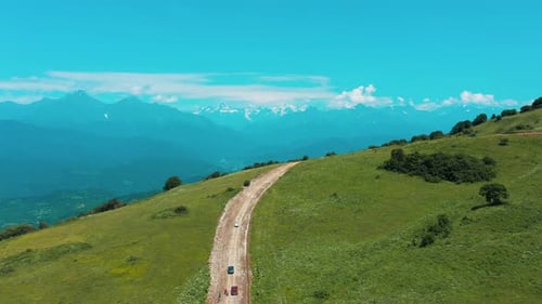 Cars Driving On The Mountain Road In Racha, Georgia On A Sunny Day - aerial tracking shot