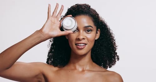 Face, woman and cream with skincare, dermatology and wellness on white studio background