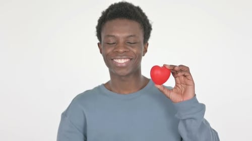 Young Adult Holding a Red Heart Smiling