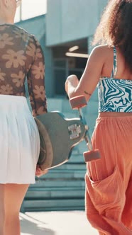 Woman, friends and skateboard in city with talking, back and outdoor on walk with trendy streetwear