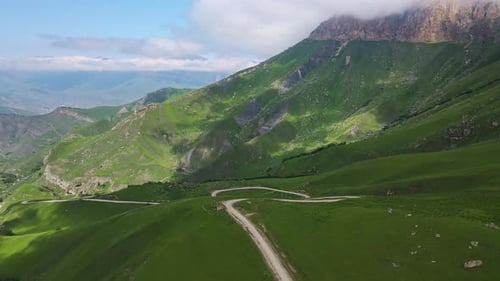 Aerial View of a Beautiful Green Valley and Road in the Mountains