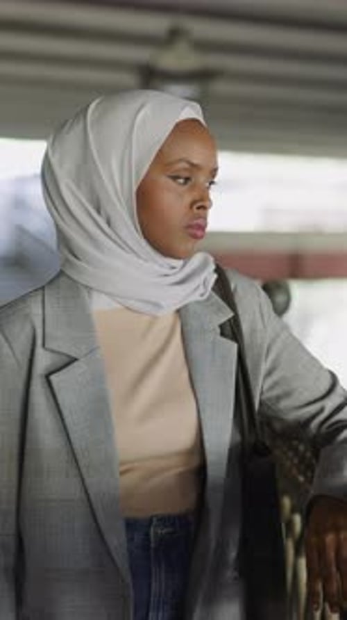 Upset AfricanAmerican Woman with Headscarf on Embankment