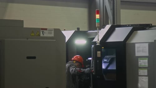 Factory Worker Operating Industrial Machine