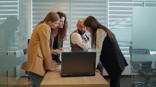 Three women and man working together planning success strategy