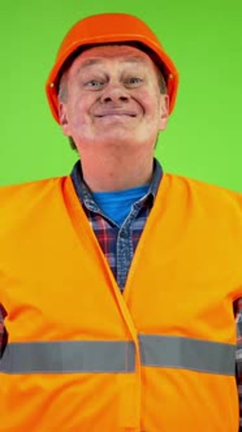 Construction Worker Points Right Wearing Hard Hat and Vest