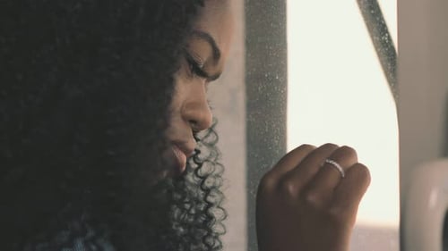 Sad Woman Looks out Window