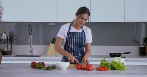 Woman Preparing Fresh Vegetables in Modern Kitchen
