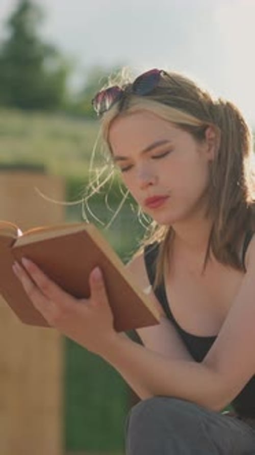 Young Woman Reading a Book in the Daytime