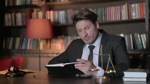 Male Lawyer Reading Law Book in Office