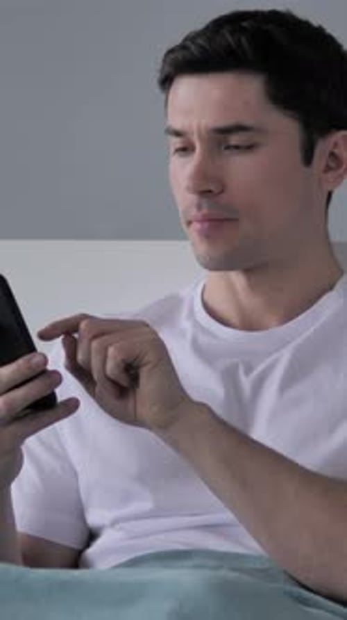 Young Man Browsing Smartphone, Using Internet, Vertical Video