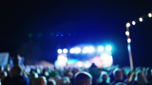 Blurred Concert Crowd at Night with Stage Lights