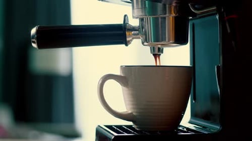 Pouring Coffee Stream From Machine in Cup Home Making Hot Espresso Using Filter Holder Flowing Fresh