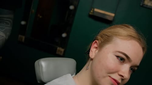 Close-up - male tattoo artist disinfects ear before piercing