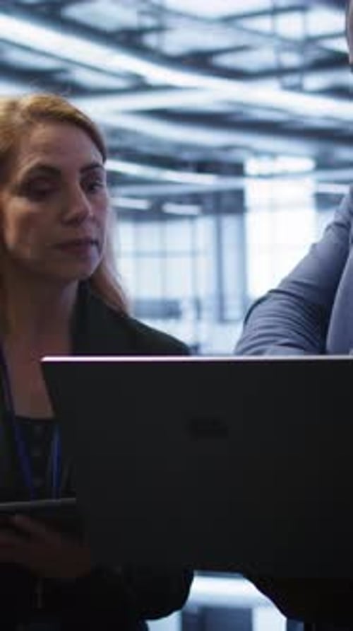 Vertical Video Coworkers in Server Room Optimizing Data Center Hardware Equipment