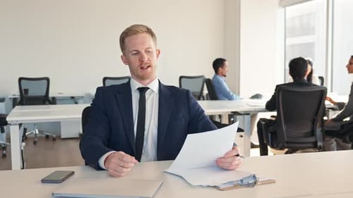 Professional Man Presents in Modern Office Setting