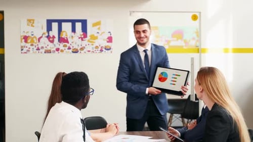 Man Giving Presentation to Team in Office