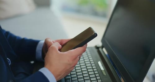 Businessman Writes Texts on Smartphone