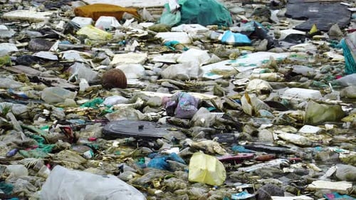Tilt-up on garbage trash leftover on ground by river bank