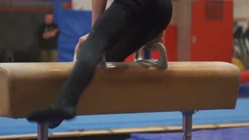 Person does gymnastics tricks on the pommel horse