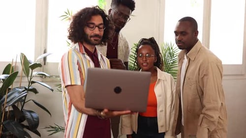 group of multiracial college students in library with laptop