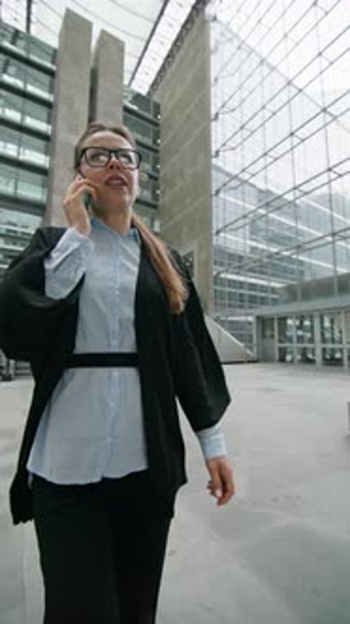Confident Woman Walks to the Modern Office Building While Speaking on the Phone