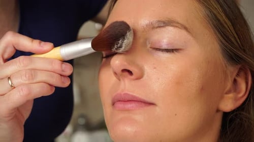 Woman Receiving Makeup Application With Brush Close Up