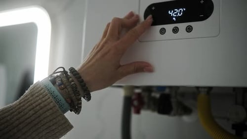Woman Starting Efficient Modern Gas Heating Boiler