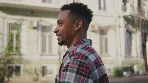 Portrait of a Young African American Man on the Street A Young Guy Stands on the Street and Camera