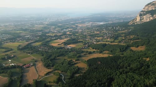 Reveal drone shot of Saleve, canton of Geneva and Lake of Geneva at sunset