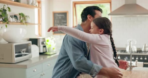 Loving Father and Daughter Share Warm Embrace in Kitchen
