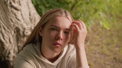 Blonde Woman Contemplating Nature in the Park