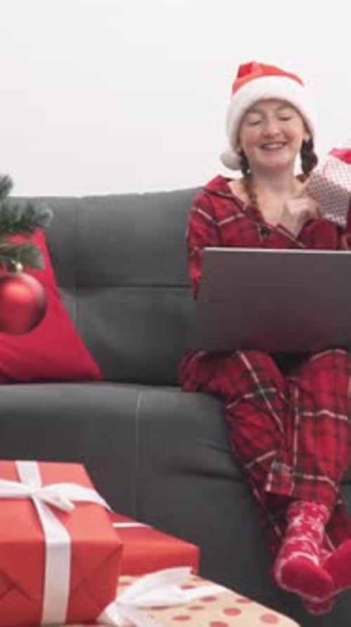 A Cheerful Child Eagerly Unwraps a Variety of Colorful Gifts Nestled Under a Beautifully Decorated