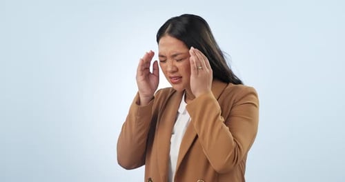 Headache, stress and business Asian woman in studio with crisis, burnout and mistake at work