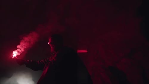 Spelunker Exploring Dark Cave with Red Flare