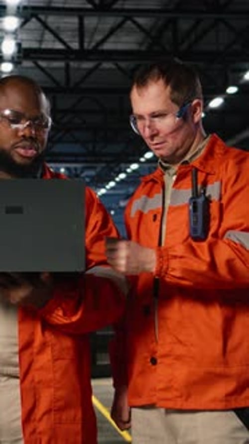 Vertical Video Technicians Team Managing Assembly Workflow with Equipment