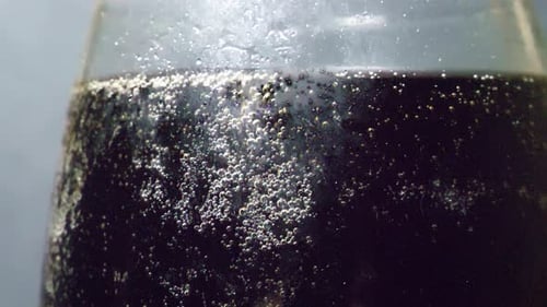 Close Up of Sparkling Cola in Glass Bottle