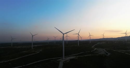 Aerial View of a Wind Farm in a Beautiful Landscape at Sunset