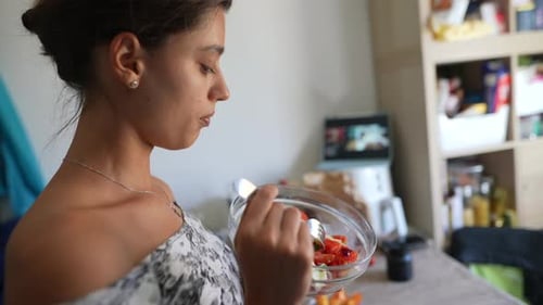 Woman Eats Fresh Salad at Home