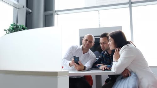 A Happy Young Couple Signs a Bank Loan Agreement with a Real Estate Agent to Buy a House