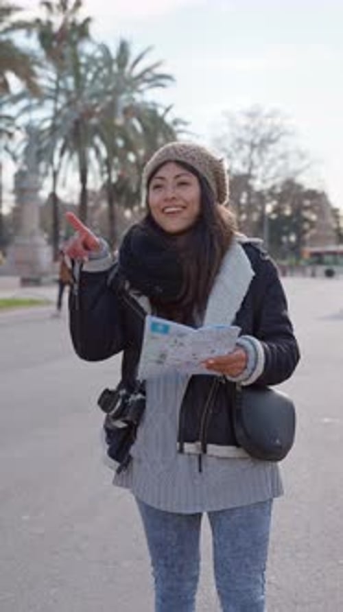 Travel Asian Tourist Woman Sightseeing Holding City Map in Winter Vacations Vertical Video
